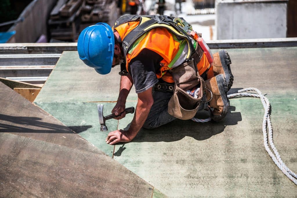 A repairman handling a roof inspection in Dallas, TX