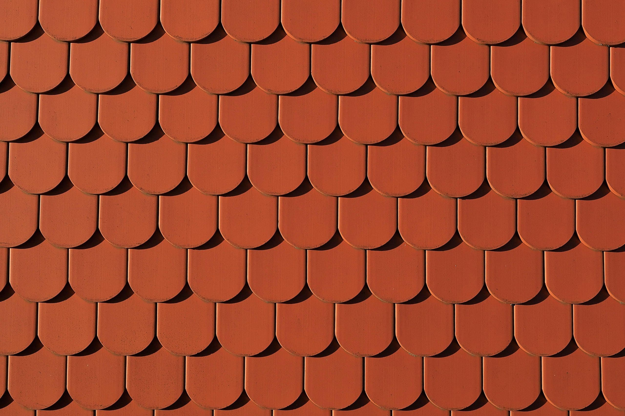 Red roof tiles on a roofing system in Dallas, TX